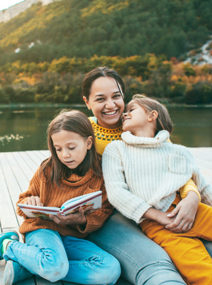 Life-Fall Man, woman, and child outdoors, with the child being held between the adults - https://krupainsurance.com